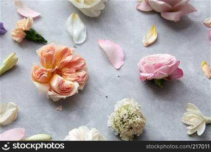 floral background of roses and petals on gray concrete background. background of flowers