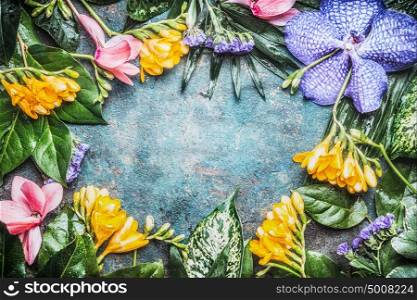Floral frame with Exotic flowers and tropical leaves, top view
