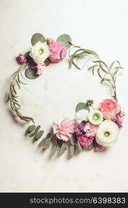 Floral round frame with eucalyptus branches and leaves, flat lay flowers, top view with copy space. Floral round frame