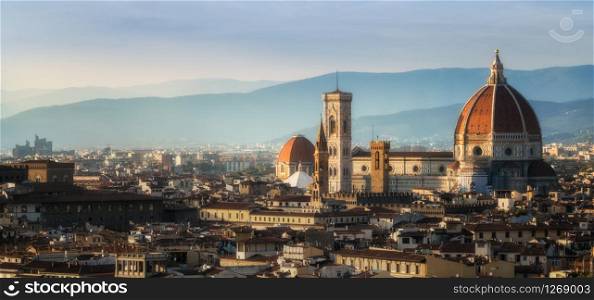 Florence Cathedral (Cattedrale di Santa Maria del Fiore) in historic center of Florence, Italy with panoramic view of the city. Florence Cathedral is the major tourist attraction of Tuscany, Italy.