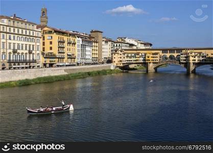 Florence, Italy - The Ponte Vecchio (Old Bridge] is a Medieval stone bridge over the Arno River. Noted for still having shops built along it, as was once common. Butchers initially occupied the shops; the present tenants are jewelers, art dealers and souvenir sellers.