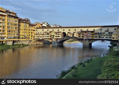 Florence, Italy - The Ponte Vecchio (Old Bridge] is a Medieval stone bridge over the Arno River. Noted for still having shops built along it, as was once common. Butchers initially occupied the shops; the present tenants are jewelers, art dealers and souvenir sellers.
