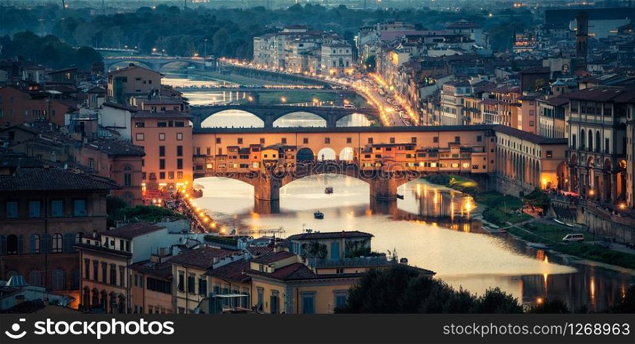 Florence Ponte Vecchio Bridge at Night Skyline in Italy. Florence is capital city of the Tuscany region of central Italy. Florence was center of Italy medieval trade and wealthiest cities of past era.
