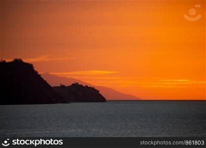 Flores island as silhouette at dusk and sunset