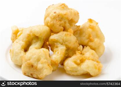 Florets of cauliflower parboiled then dipped in batter and deep fried