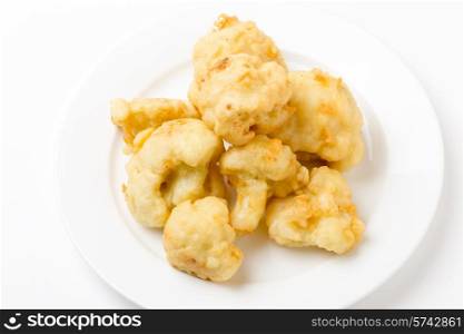 Florets of cauliflower parboiled then dipped in batter and deep fried