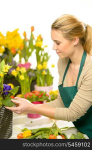 Florist arrange spring flowers colorful potted narcissus, tulips