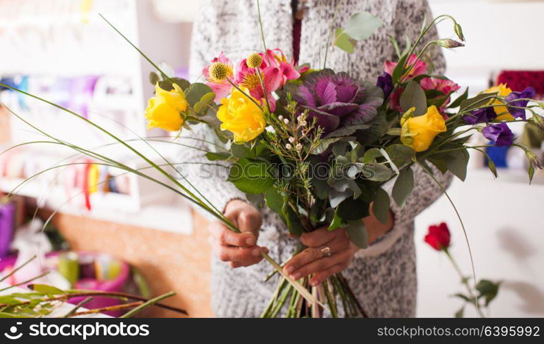 Florist making fashion bouquet of colorfull flowers. Florist making a bouquet