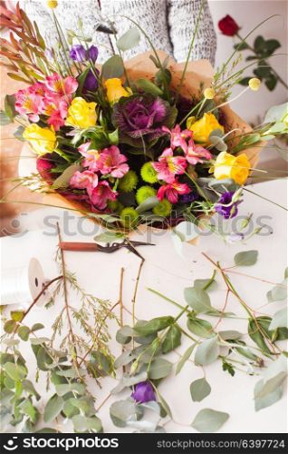 Florist making fashion bouquet of colorfull flowers. Florist making a bouquet