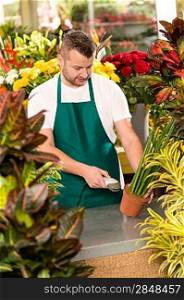 Florist man reading barcode potted plant shop market flower