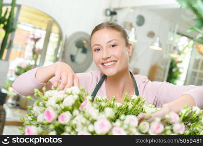 Florist standing behind cut flowers