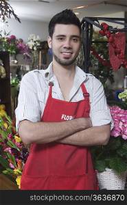 Florist stands with arms folded