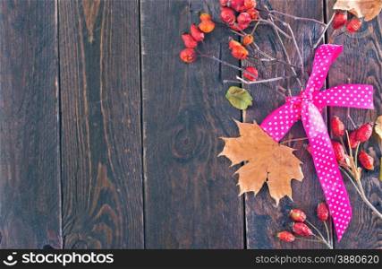Florist table for Making autumn decorations with leafs,shears and ribbon