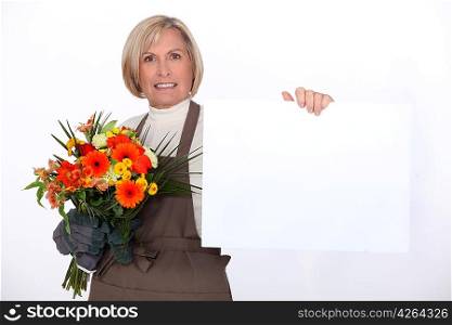 Florist with a bouquet and a board left blank for your message