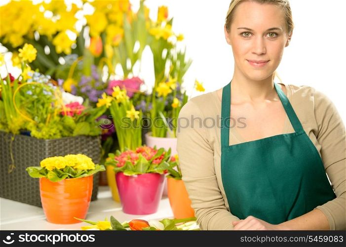 Florist with spring potted flowers colorful looking at camera