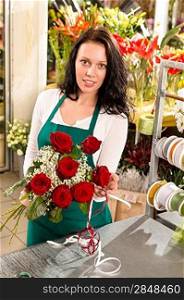 Florist woman arranging flowers roses shop working retail bouquet
