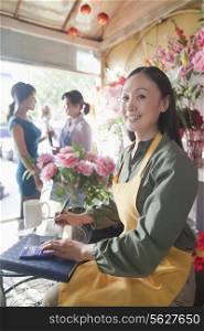 Florist Working In Flower Shop