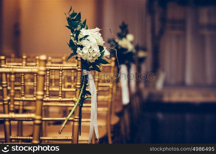 Floristic design on wedding ceremony day. Buch of flowers in wedding hall.
