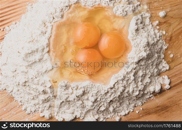 Flour and eggs as ingredients for making pasta dough.