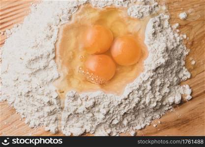 Flour and eggs as ingredients for making pasta dough.