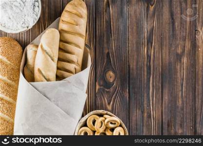 flour baguettes bagels wooden background