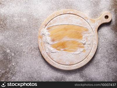 Flour food and pizza cutting board as bakery concept for homemade bread baking on table. Recipe top view at stone background texture with copy space, flat lay concept