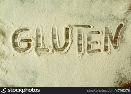 Flour on the table with writted word GLUTEN