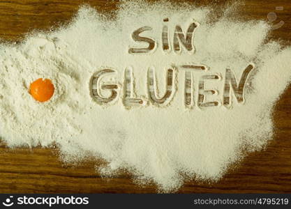 Flour on the table with writted word SIN GLUTEN