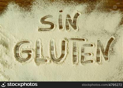 Flour on the table with writted word SIN GLUTEN