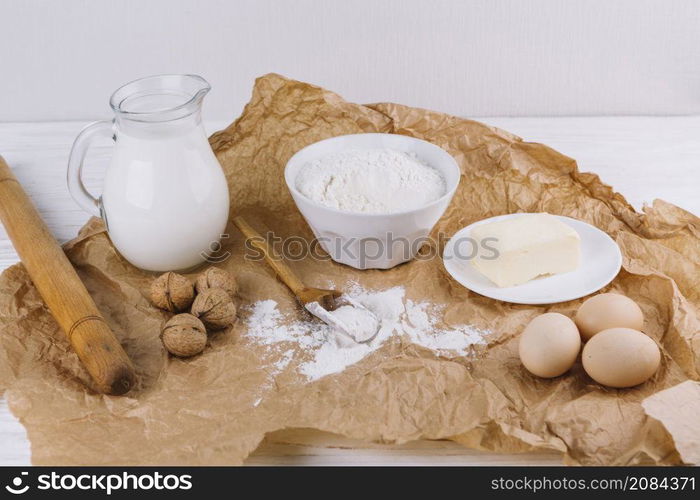 flour walnuts eggs cheese rolling pin brown crumpled paper