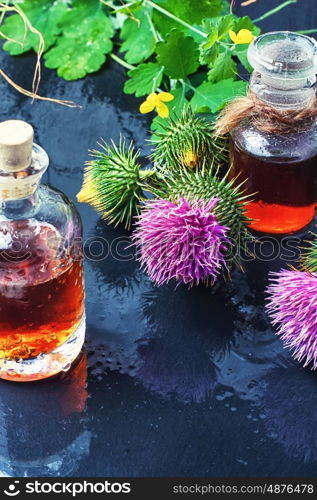 Flower and burdock extract. Buds medicinal wild plants burdock and burdocks medicinal tincture