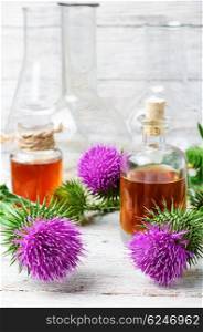 Flower and burdock extract. Buds medicinal wild plants burdock and burdocks medicinal tincture from it