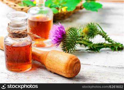 Flower and burdock extract. Buds wild plants burdock and burdocks medicinal tincture from it
