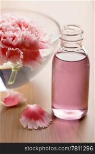 flower and essential oil in bottle. spa and body care background