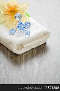 flower and massager on white towel