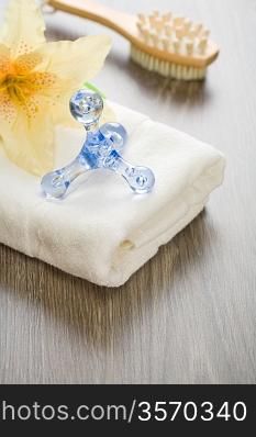 flower and massager on white towel with massager