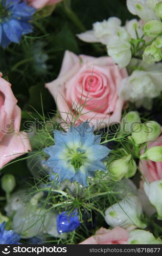 Flower arrangement in blue and pink, roses and love in a mist