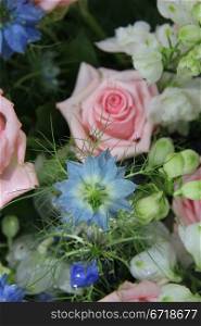 Flower arrangement in blue and pink, roses and love in a mist