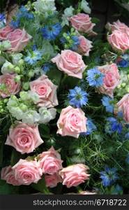 Flower arrangement in blue and pink, roses and love in a mist