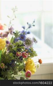 Flower arrangement in front of window.