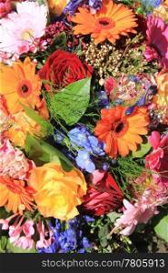 Flower arrangement in many bright colors and different sorts of flowers