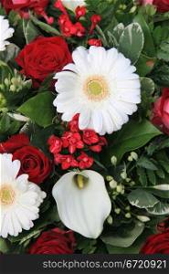 Flower arrangement in red and white with arums and roses