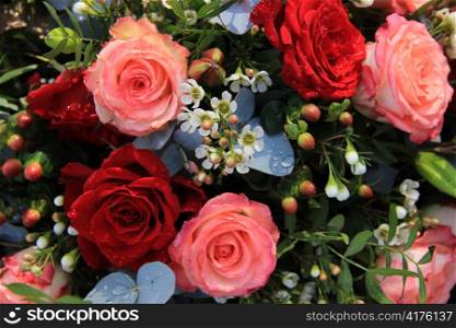 Flower arrangement with big pink and red roses
