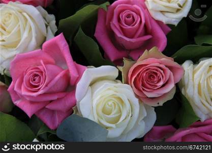 Flower arrangement with roses in white and different shades of pink