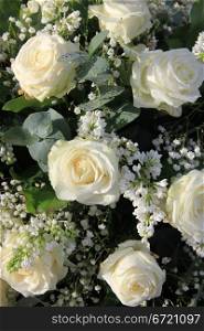 Flower arrangement with white roses and syringa