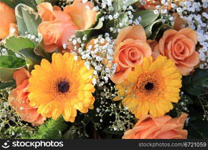 Flower arrangement with yellow and orange gerberas and roses