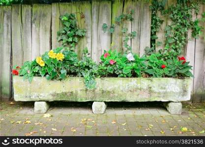 Flower bed near board fence