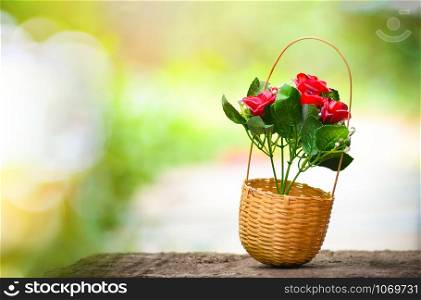 Flower bouquet in bamboo basket with summer nature green and yellow background