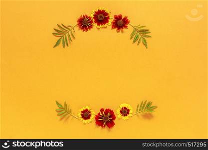 Flower composition. Frame floral round wreath of yellow red flowers on orange background. Flat lay Top-down composition. Copy space Mock up Template for postcard, lettering text or your design.. Flower composition. Frame floral round wreath of yellow red flowers on orange background. Flat lay Top-down composition. Copy space Mock up Template for postcard, lettering text or your design