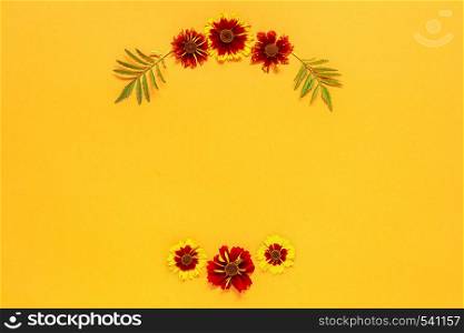 Flower composition. Frame floral round wreath of yellow red flowers on orange background. Flat lay Top-down composition. Copy space Mock up Template for postcard, lettering text or your design.. Flower composition. Frame floral round wreath of yellow red flowers on orange background. Flat lay Top-down composition. Copy space Mock up Template for postcard, lettering text or your design